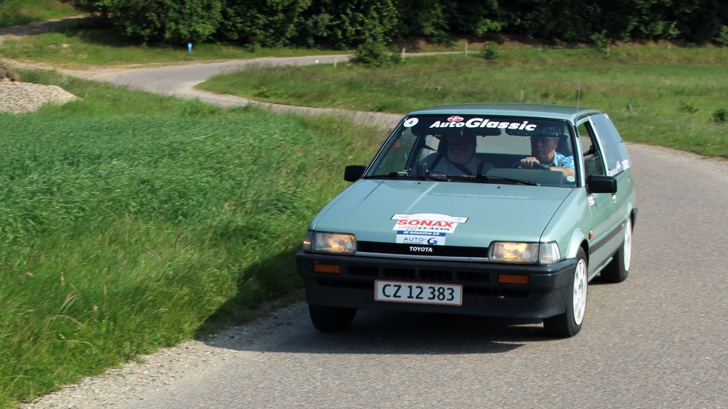 Det mesterskabs førende hold i Elite-klassen, Poul og Erik Brøndum, Randers ses her, i deres Corolla fra 1985, runde et par sving i 3. afdeling, der blev kørt omkring Aars i juni måned.
(Foto: Bjarne Andersen)
